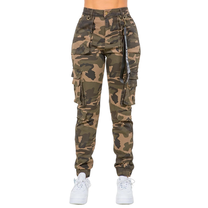 a woman wearing camouflage cargo pants and white sneakers