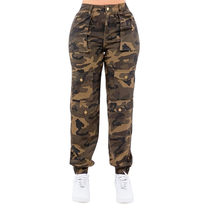 a woman wearing camouflage pants and white sneakers