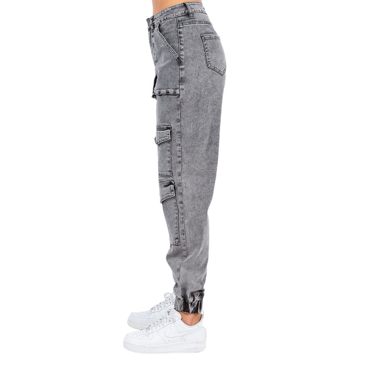 a person wearing grey jeans and white sneakers