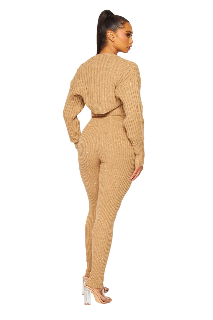 a woman in a tan sweater and pants