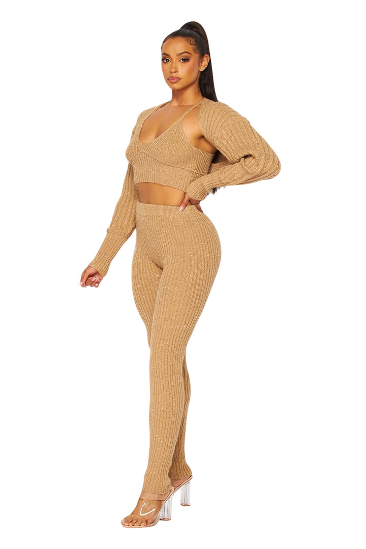 a woman in a tan sweater and pants