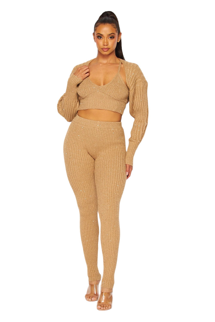 a woman wearing a tan sweater and matching pants