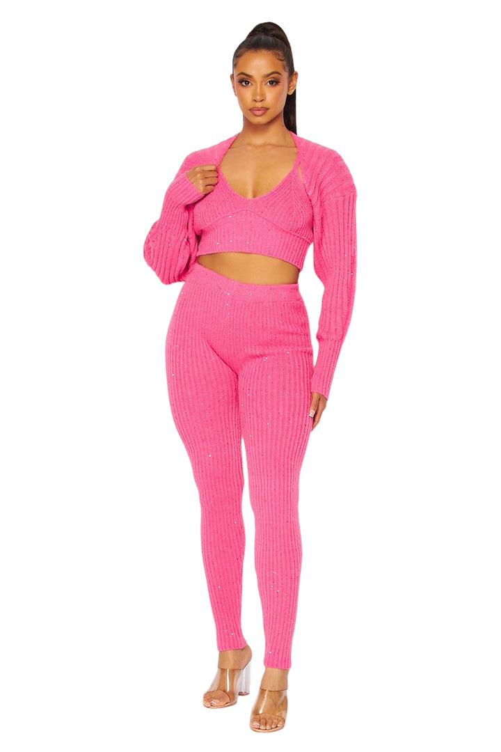 a woman wearing a pink sweater and matching pants