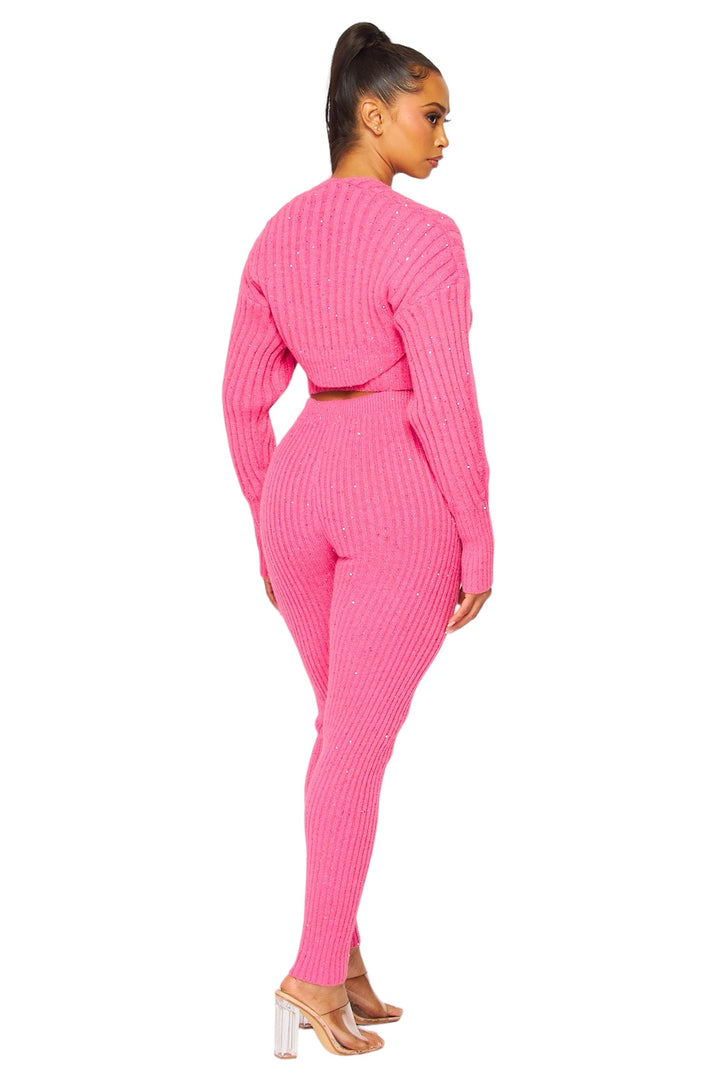 a woman in a pink sweater and pants