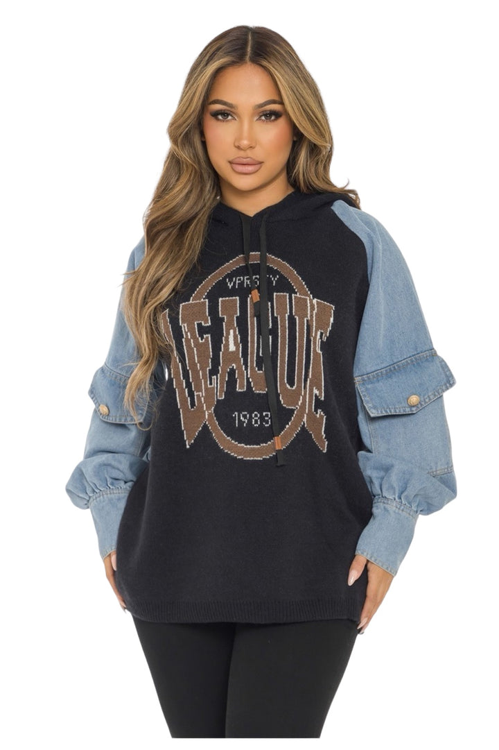a woman wearing a black hoodie and jeans