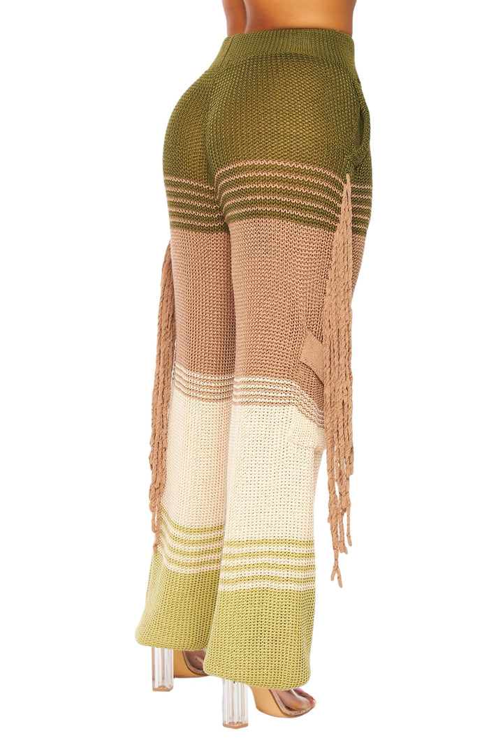 a woman is wearing a pair of pants with fringes