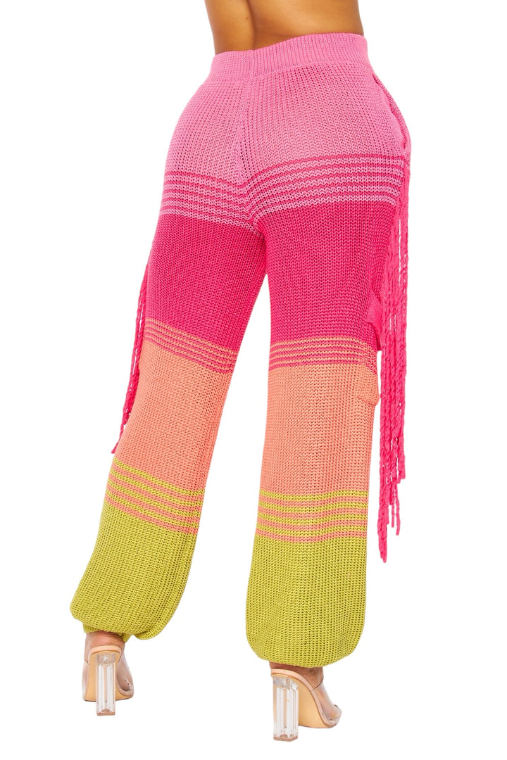 a woman in pink and yellow pants and heels