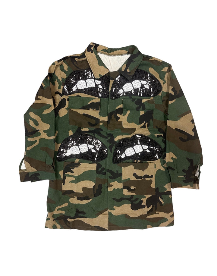 a camo jacket with a face drawn on it