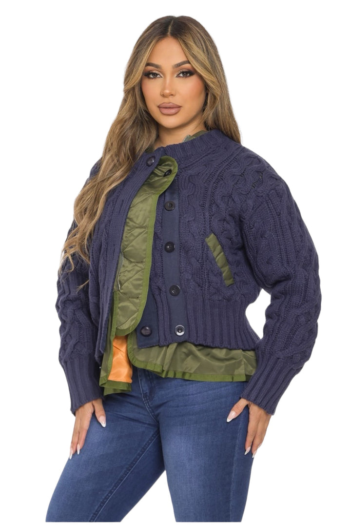 a woman wearing a blue cable knit jacket