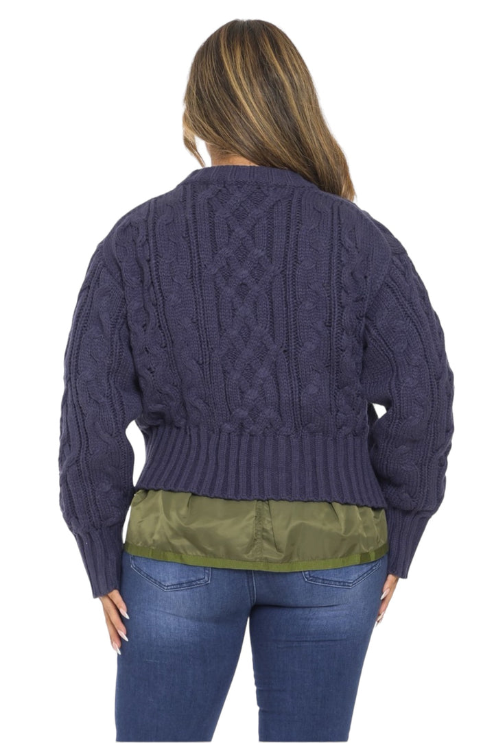 a woman wearing a purple cable knit sweater