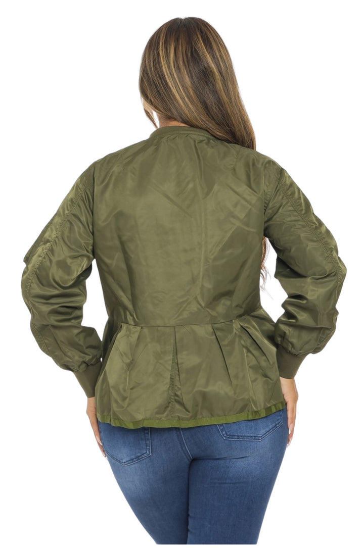 a woman wearing a green jacket and jeans
