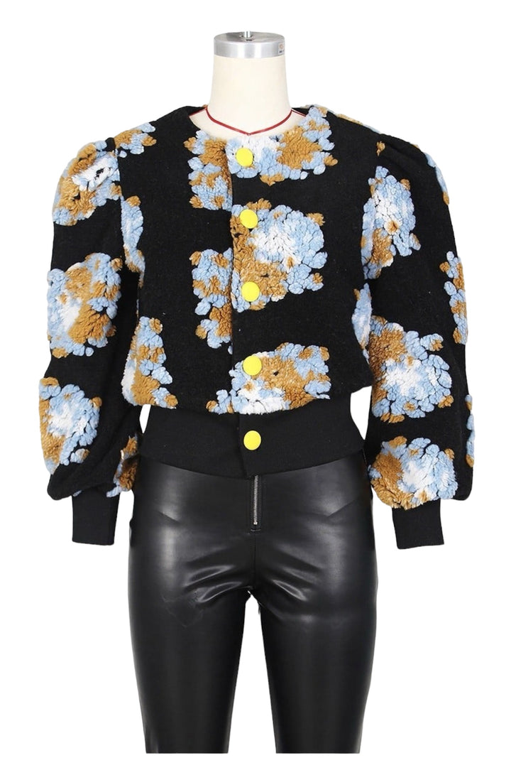 a mannequin wearing a jacket with flowers on it