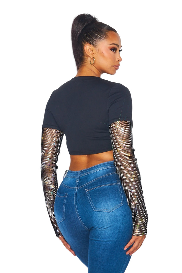 a woman wearing a black top and jeans