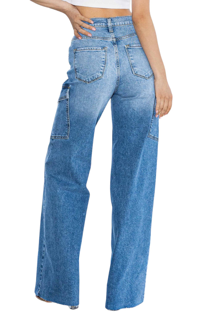 a woman in a white top and blue jeans