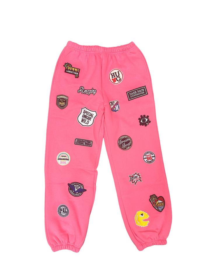 a pair of pink pants with patches on them