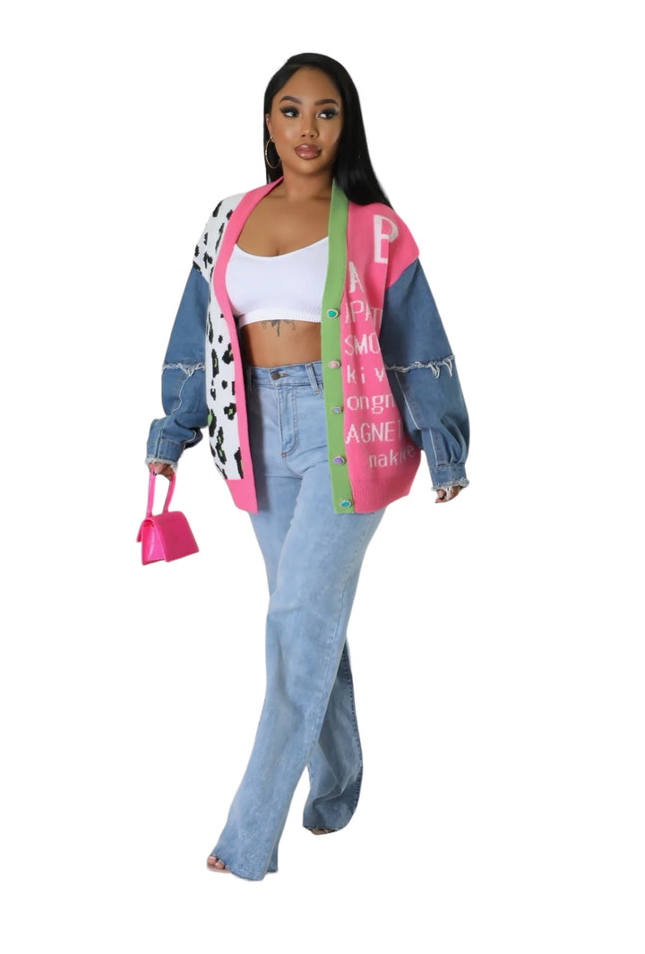 a woman in a pink and blue jacket and jeans
