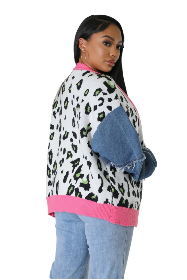 a woman wearing a leopard print sweater and jeans