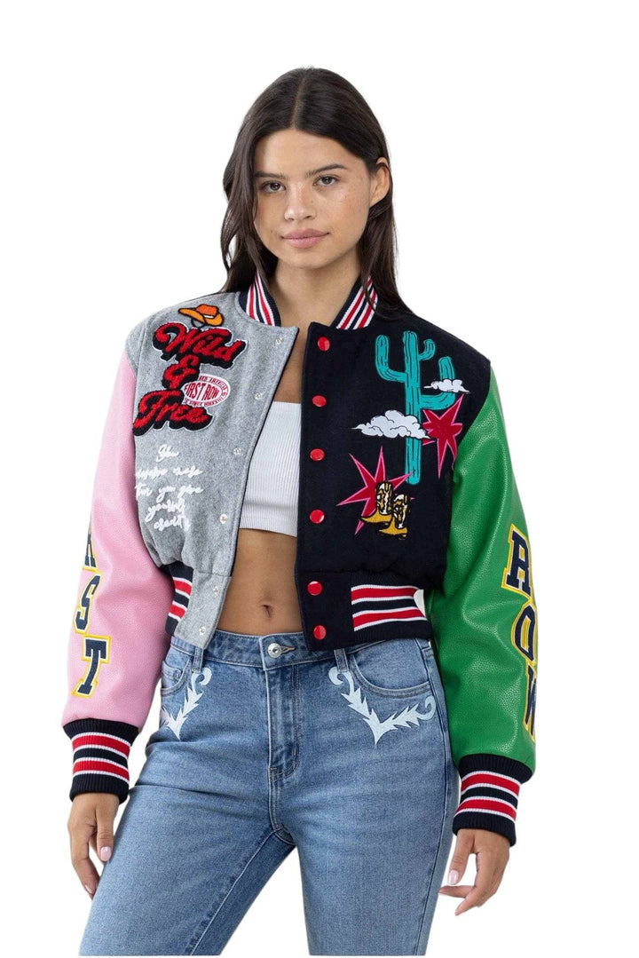 a woman wearing a colorful jacket and jeans