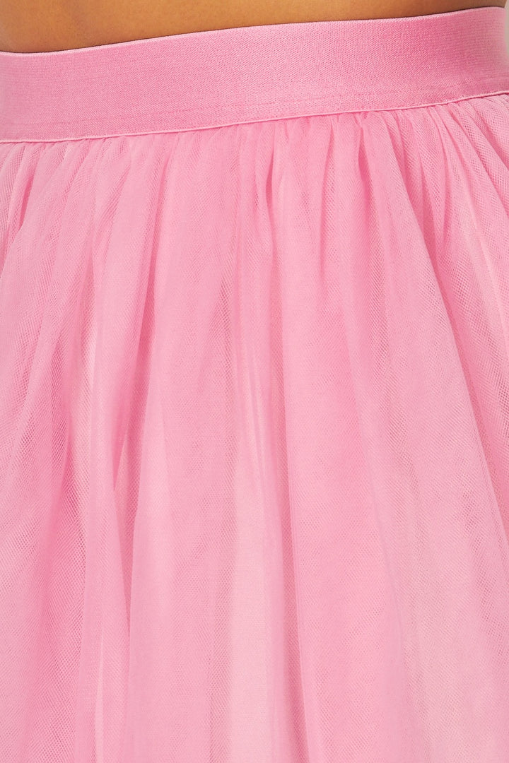 a close up of a person wearing a pink skirt