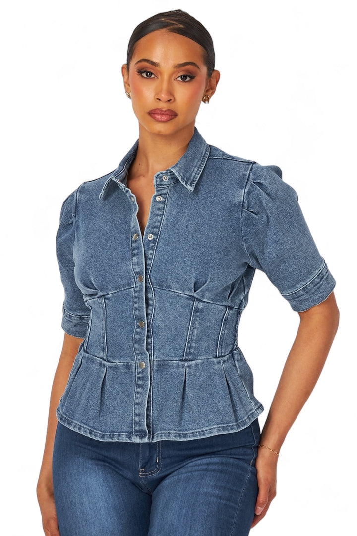 a woman wearing a denim shirt and jeans