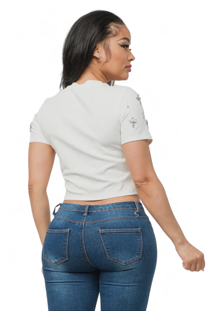 a woman wearing a white shirt and jeans