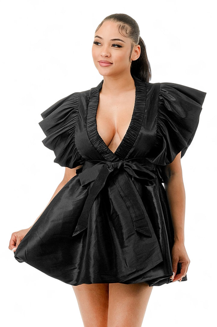 a woman in a black dress posing for a picture