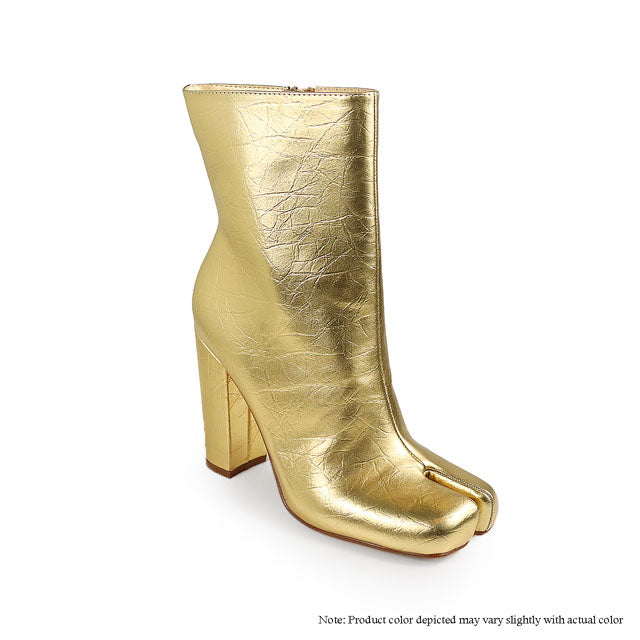 a pair of gold high heeled boots on a white background