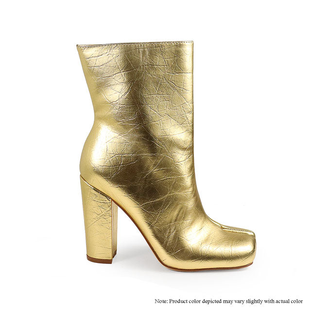 a gold high heeled boot with a metallic finish