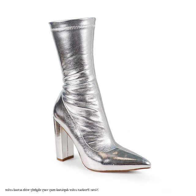 a pair of silver high heeled boots on a white background