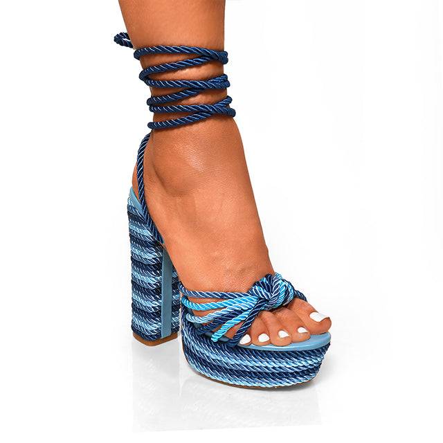 a woman's legs wearing blue and white shoes