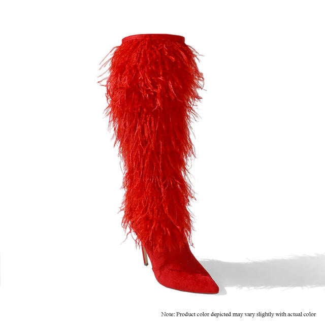 a pair of red high heeled boots with feathers
