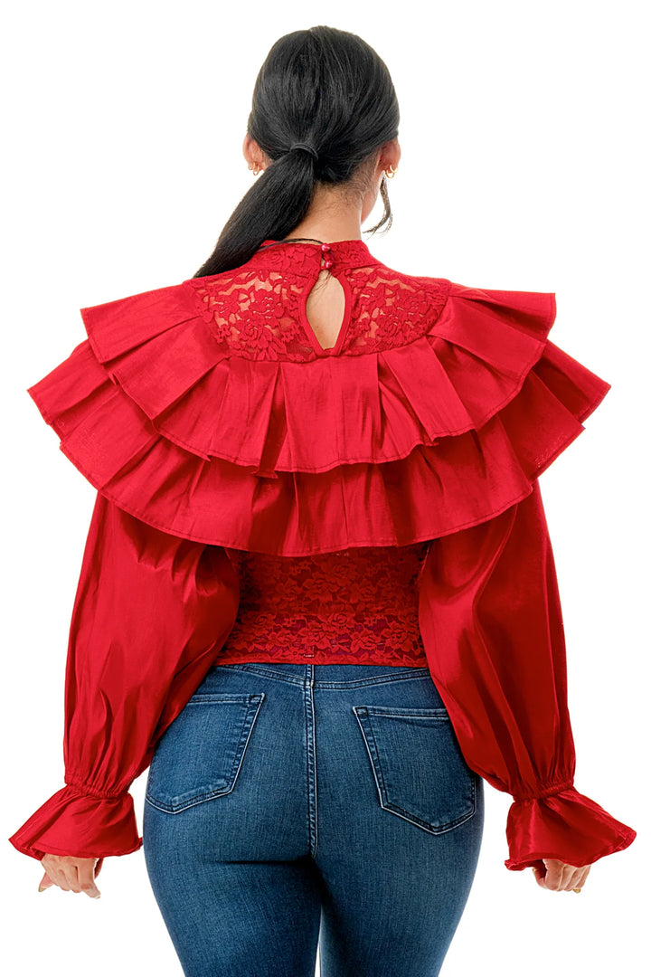 a woman wearing a red blouse and jeans
