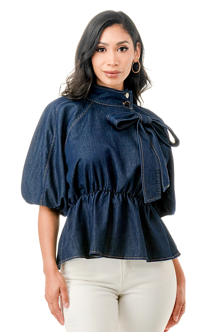 a woman in white pants and a denim top