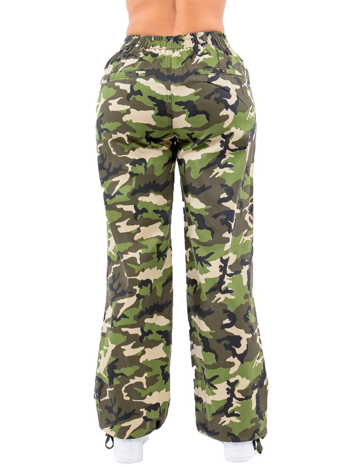 a woman in camouflage print pants with her back turned