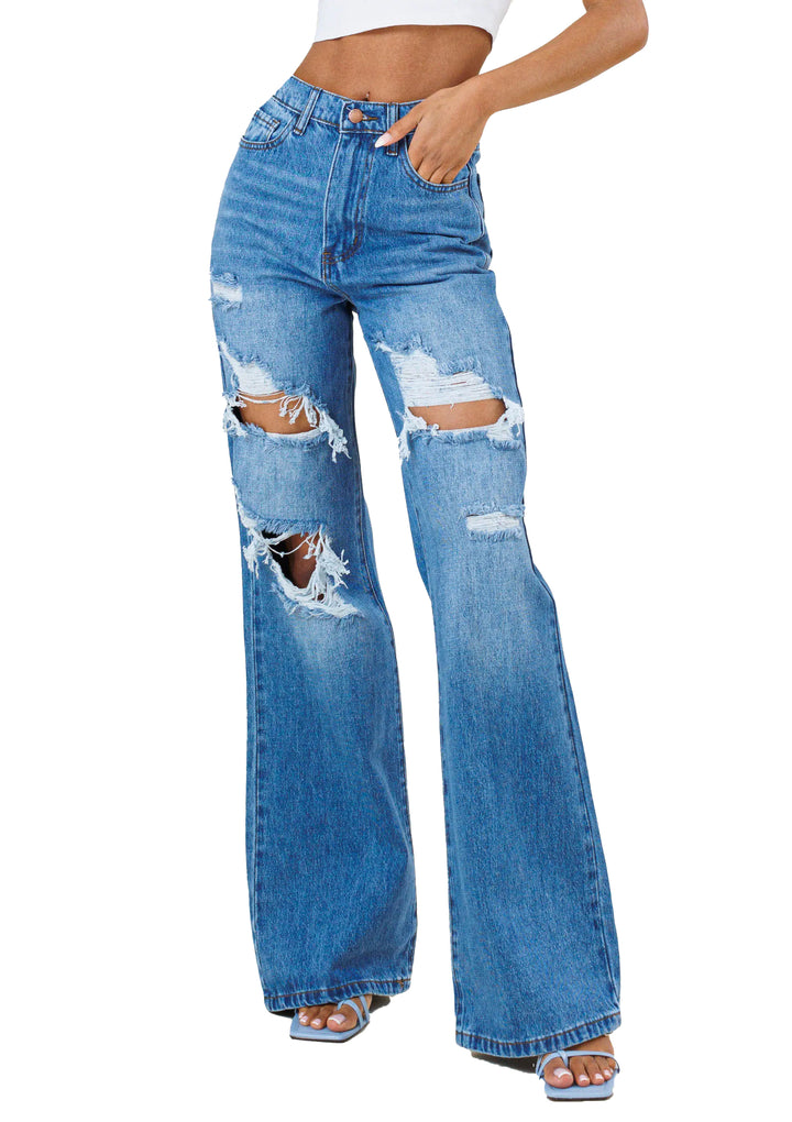 a woman in a white top and blue jeans