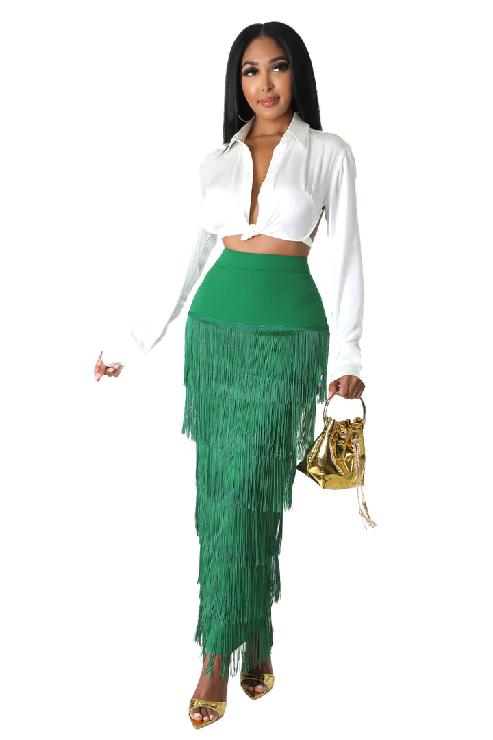 a woman in a white shirt and green skirt