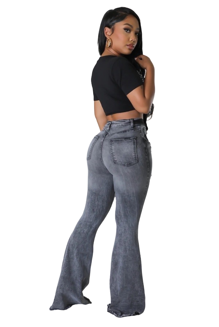 a woman in a black top and grey jeans
