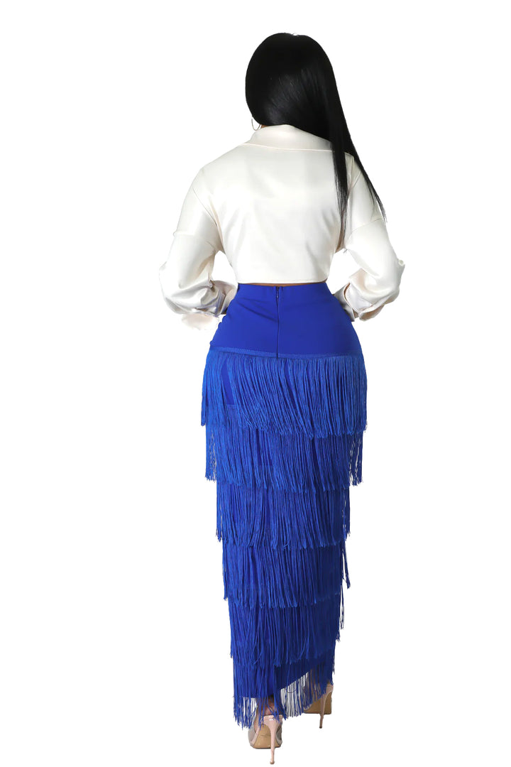 a woman in a white shirt and blue skirt
