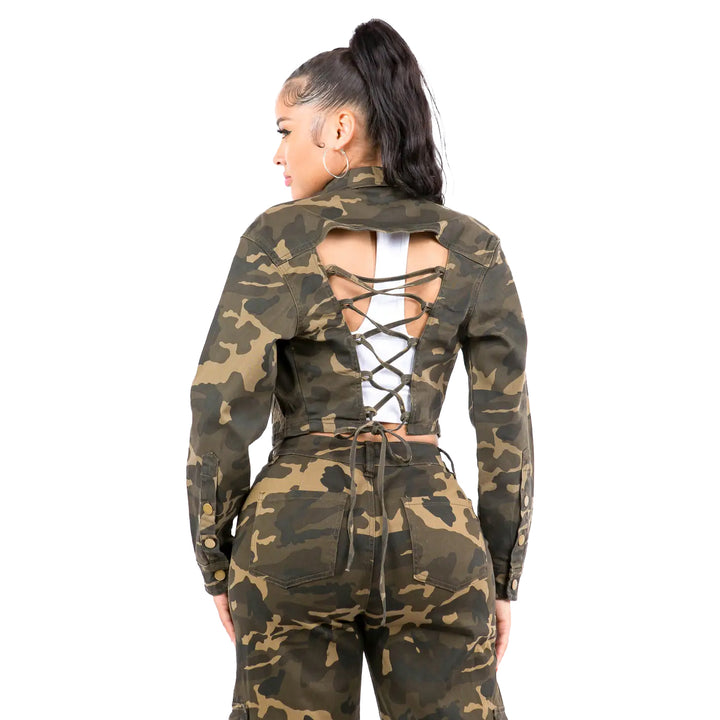 a woman wearing a camo suit with lace up back