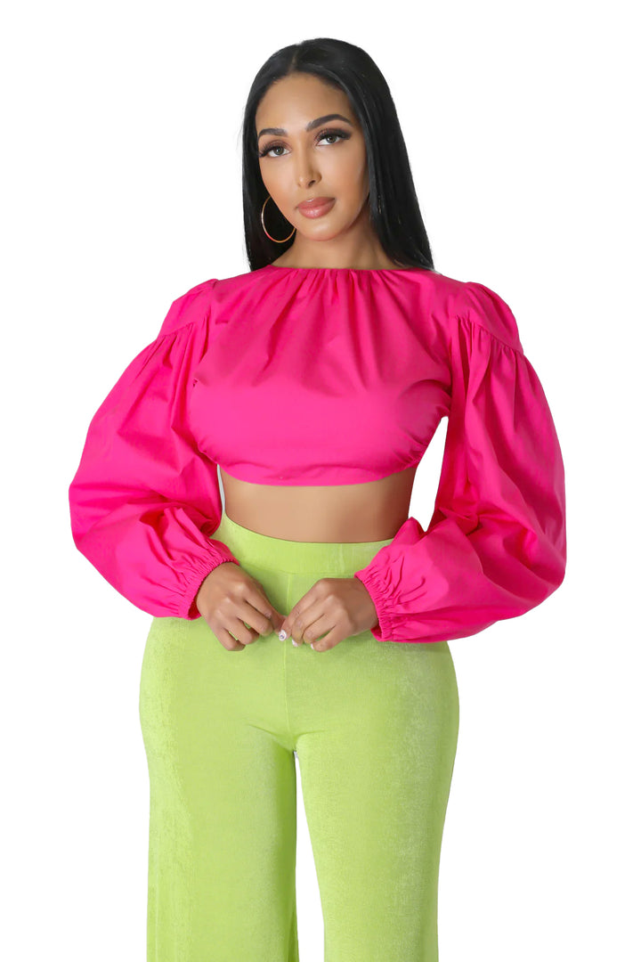 a woman wearing neon green pants and a pink top