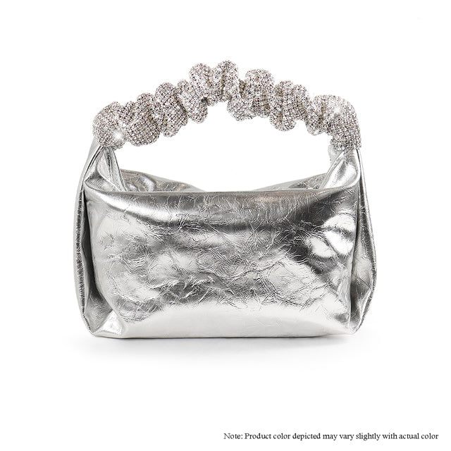 a silver purse with a chain on top of it