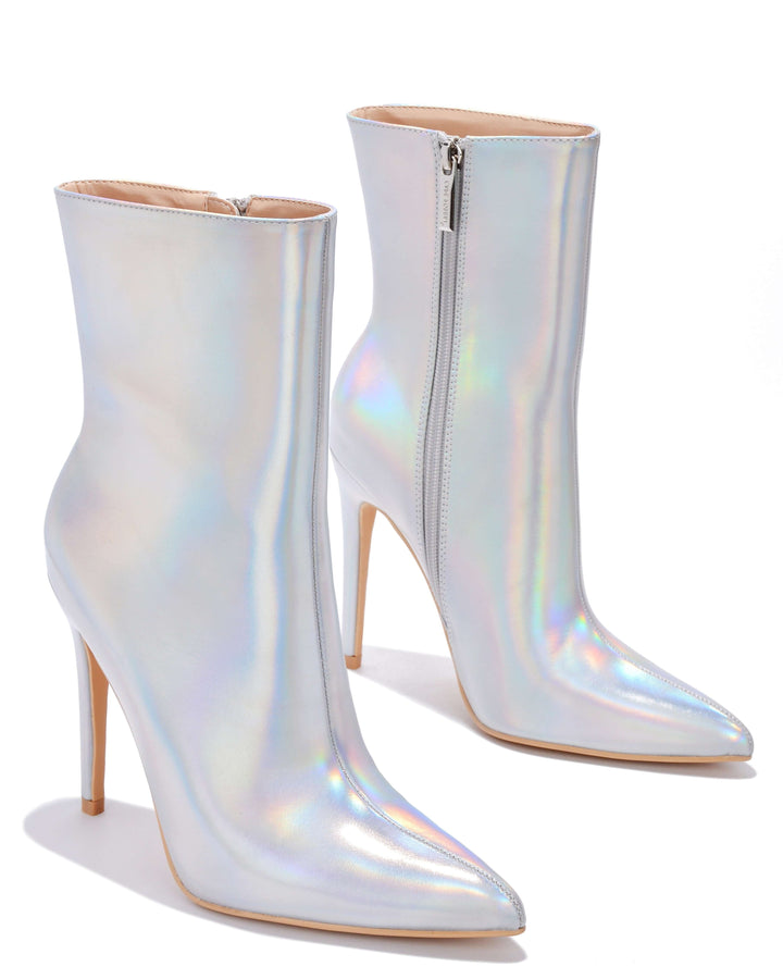 a pair of white high heel boots with a zipper