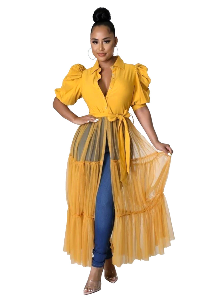 a woman wearing a yellow dress with a sheer skirt