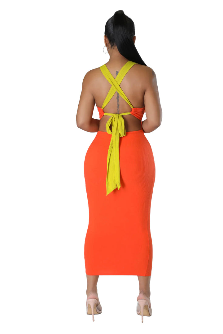 a woman in an orange and yellow dress