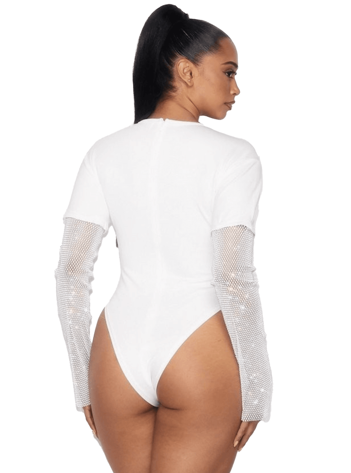 a woman wearing a white bodysuit with sheer sleeves