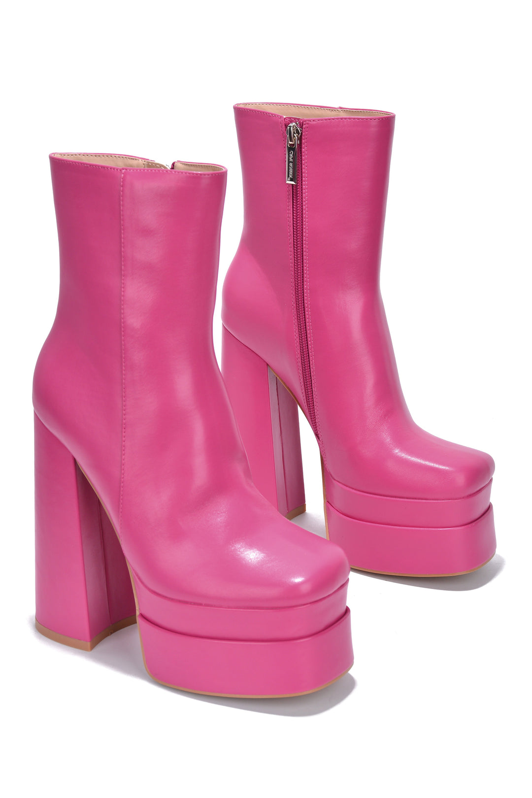 a pair of pink high heeled boots