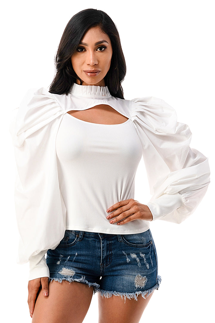 a woman wearing a white top and denim shorts