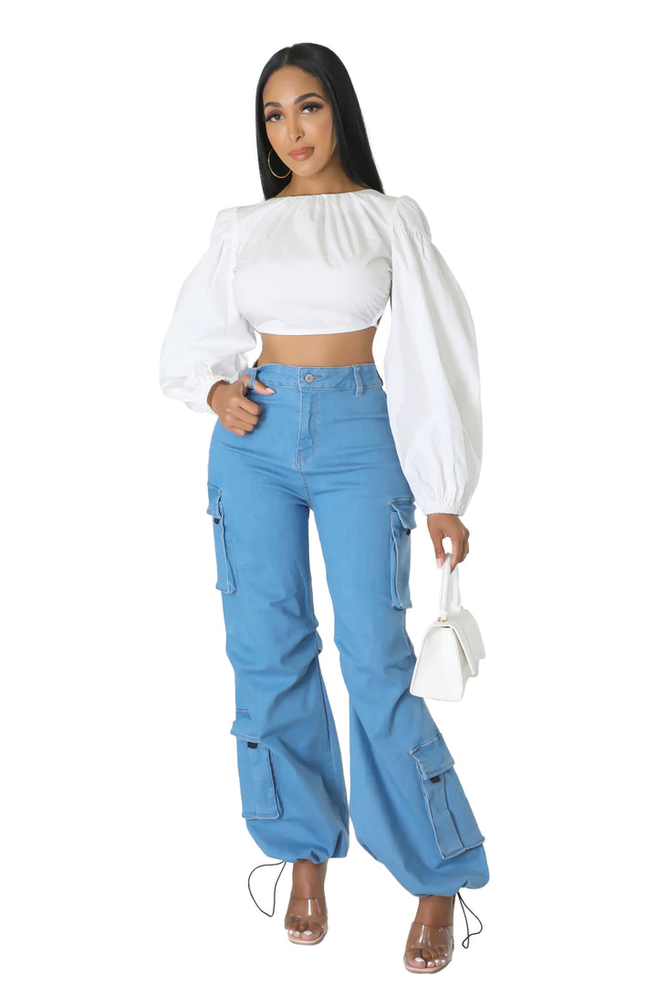 a woman in a white top and blue pants