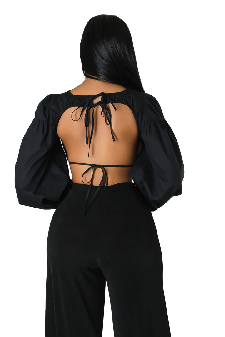 a woman wearing a black top and pants
