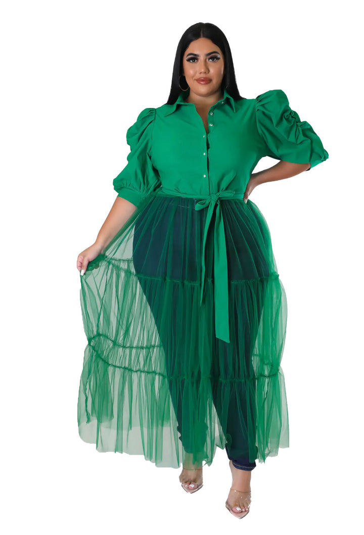 a woman wearing a green dress with a long skirt